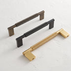 Trio de poignées Crux — bronze antique, noir mat, laiton brossé
