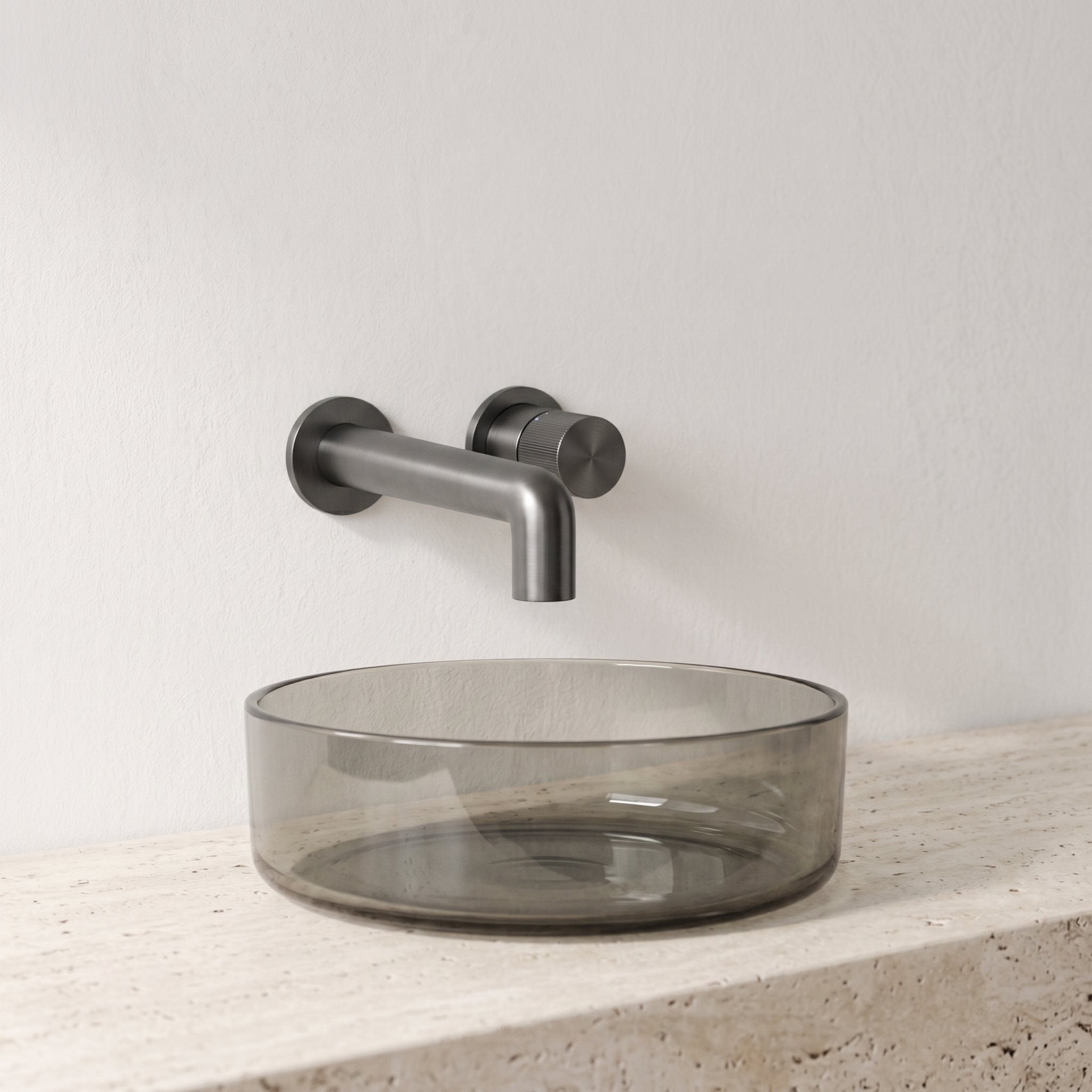 Robinet mural encastrable Muro gun metal au-dessus d'une vasque en verre fumé